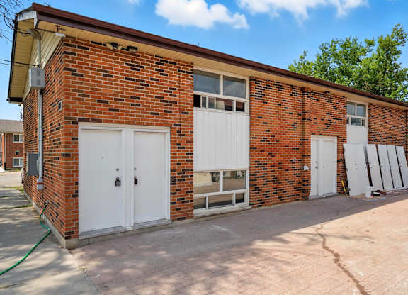 A red brick building with white garage doors.